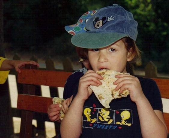 A Child Eating Fresh-Baked Pita